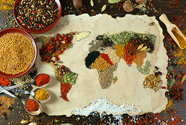 Map of world made from different kinds of spices on wooden backg
